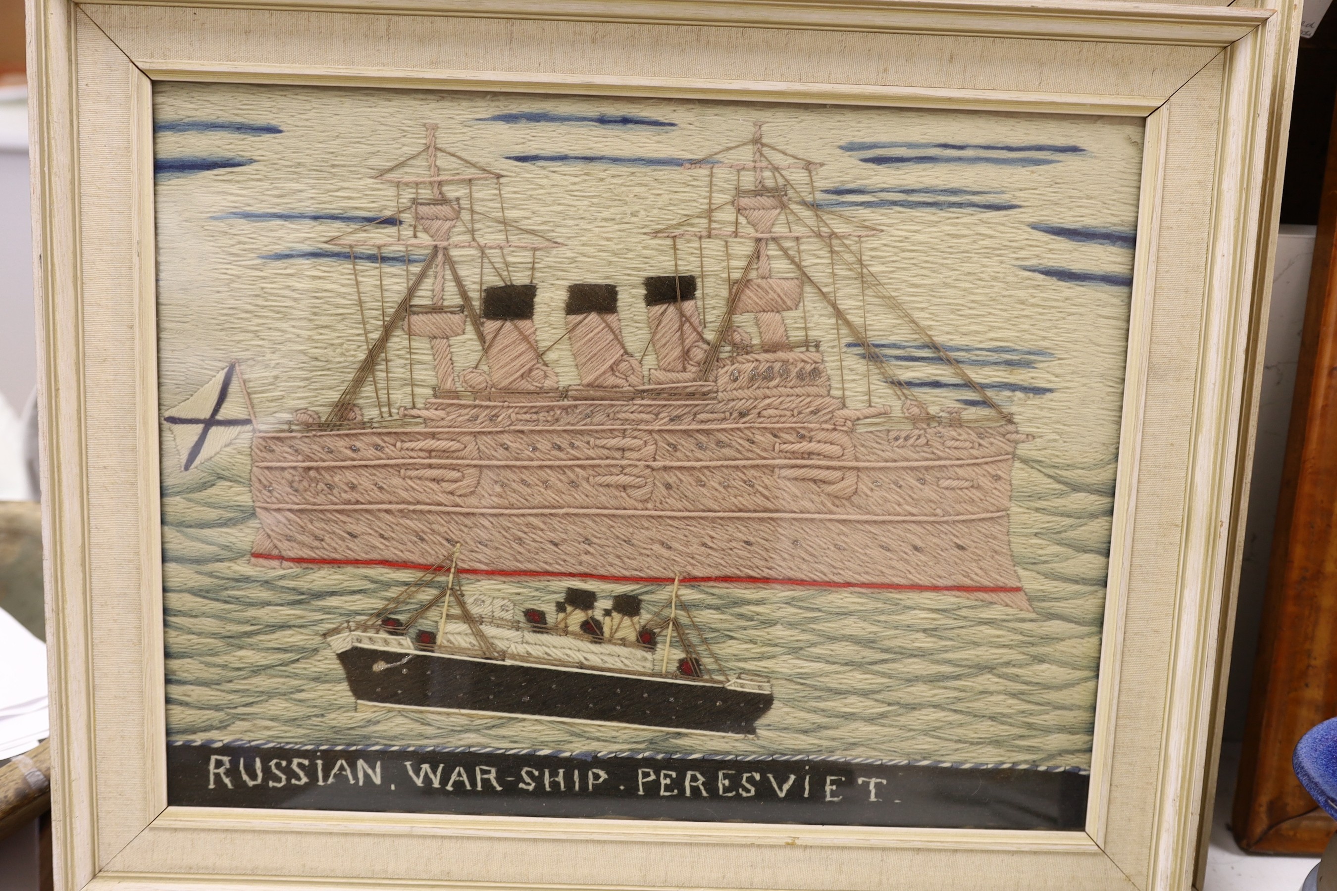 A pair of woolwork ship portraits, HMS Birmingham and Russian Warship Peresviet, a smaller woolwork of a sailing boat and a Berlin woolwork of a biblical scene, HMS Birmingham: 49cms wide x 39cm high